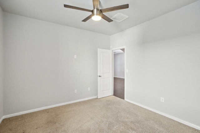 carpeted spare room featuring ceiling fan