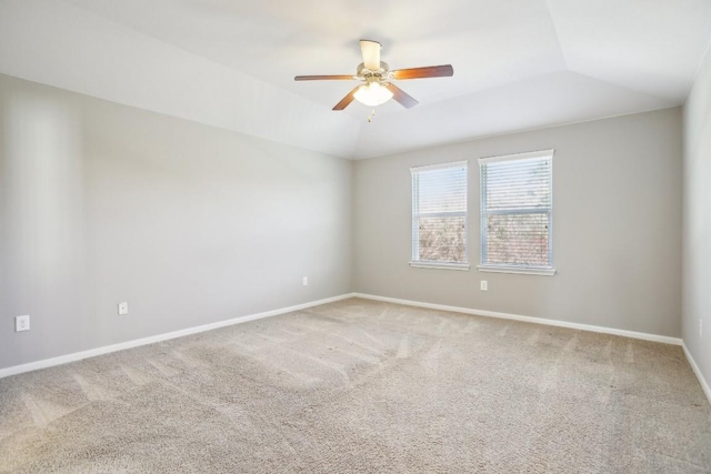 empty room with ceiling fan, carpet floors, and lofted ceiling