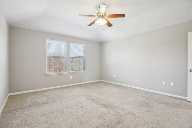 unfurnished room with carpet flooring, ceiling fan, and a raised ceiling