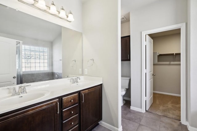 bathroom featuring tile patterned floors, vanity, and toilet