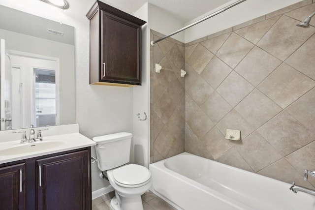 full bathroom with vanity, tiled shower / bath combo, and toilet