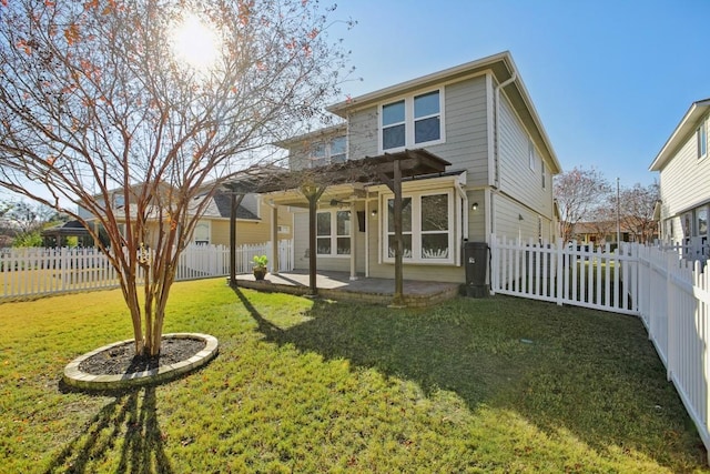 back of house featuring a lawn and a patio area