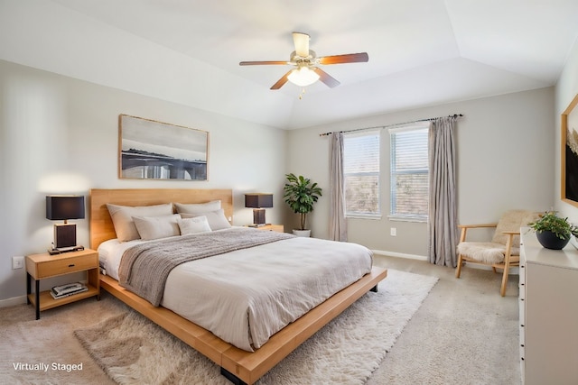 bedroom featuring light colored carpet, vaulted ceiling, and ceiling fan