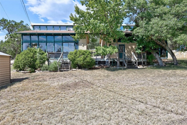 back of property with a sunroom