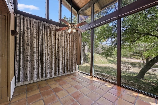 unfurnished sunroom with wooden ceiling, ceiling fan, and lofted ceiling with beams