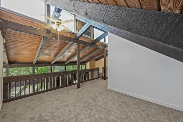 exterior space with carpet, vaulted ceiling with beams, ceiling fan, and wooden ceiling