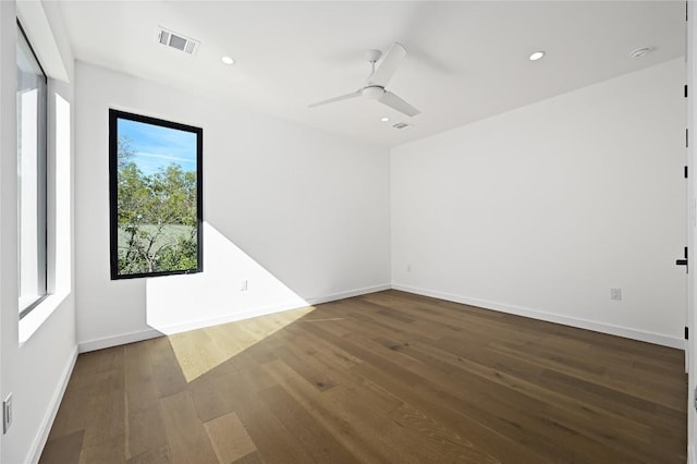 spare room with dark hardwood / wood-style floors and ceiling fan