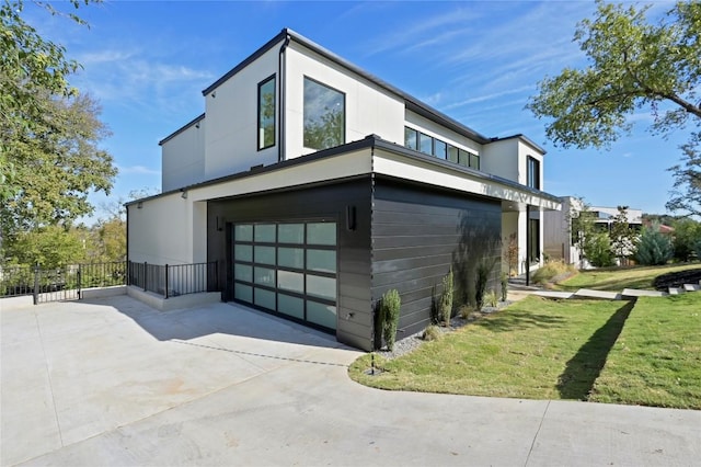 view of home's exterior featuring a yard and a garage