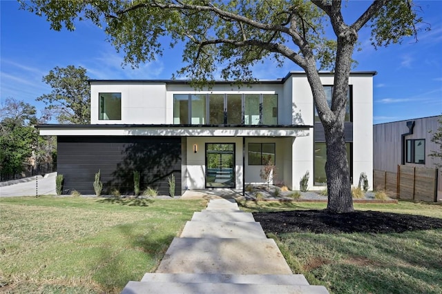 modern home featuring covered porch and a front yard