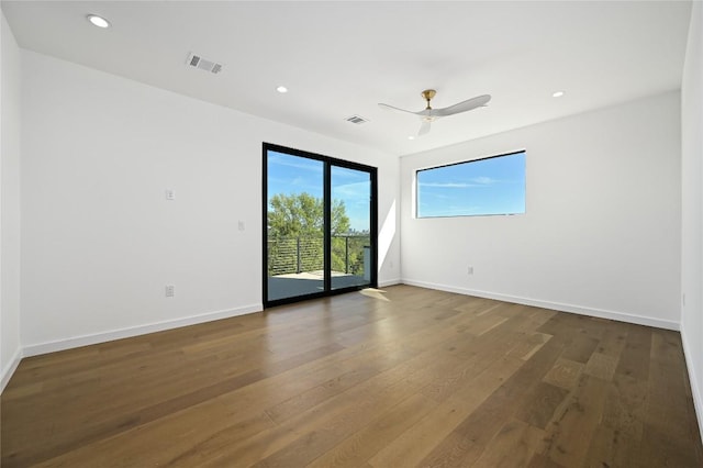 empty room with hardwood / wood-style flooring and ceiling fan