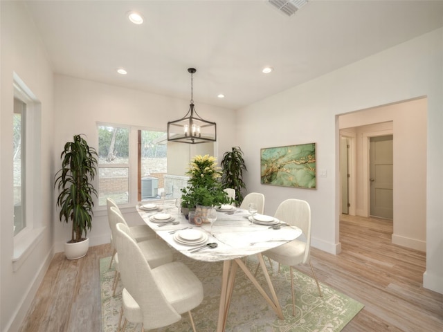 dining space featuring a chandelier and light hardwood / wood-style flooring