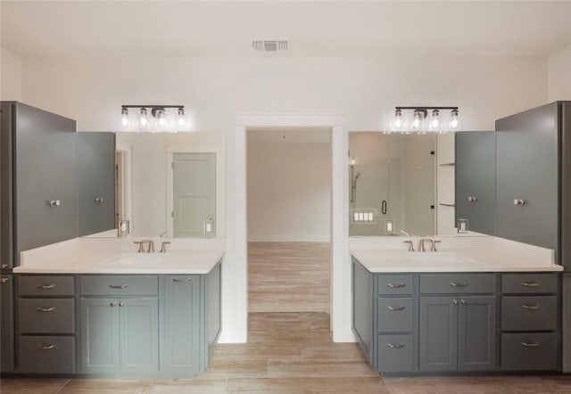 bathroom with hardwood / wood-style floors and vanity