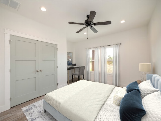 bedroom featuring a closet, ceiling fan, and light hardwood / wood-style flooring