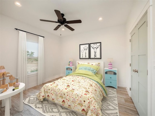 bedroom with ceiling fan and light wood-type flooring