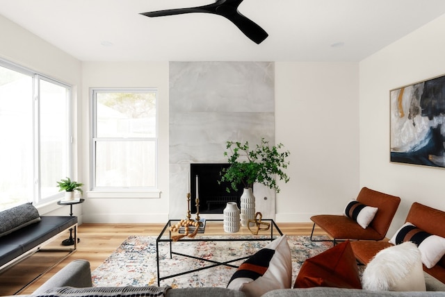 living room featuring ceiling fan and light hardwood / wood-style floors