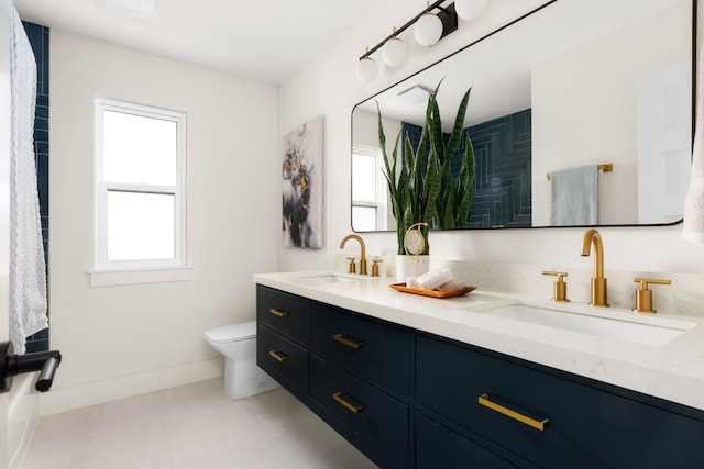 bathroom featuring tile patterned floors, vanity, and toilet