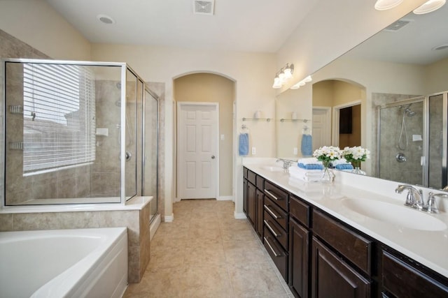 bathroom featuring tile patterned flooring, vanity, and plus walk in shower