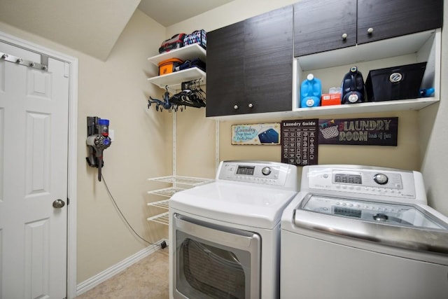 laundry area with cabinets, light tile patterned floors, and separate washer and dryer