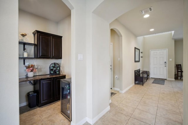 hallway featuring light tile patterned floors and wine cooler