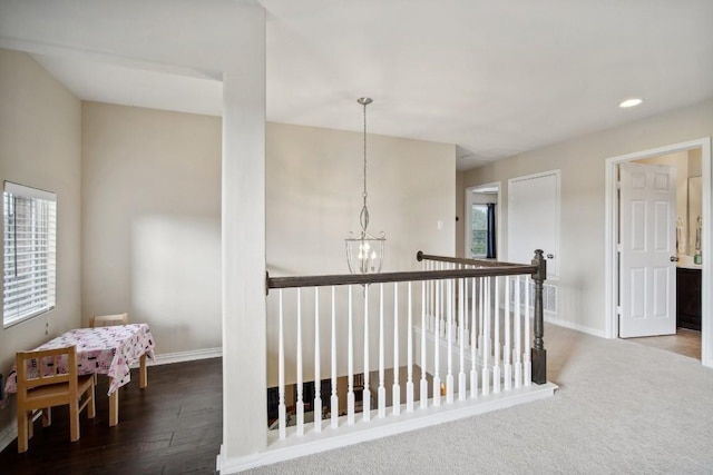 hall featuring an inviting chandelier