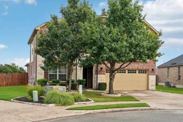 view of property hidden behind natural elements with a garage and a front lawn