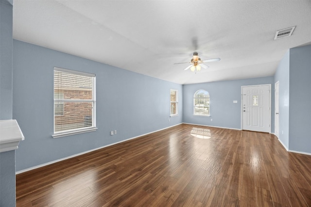 unfurnished living room with ceiling fan and dark hardwood / wood-style floors