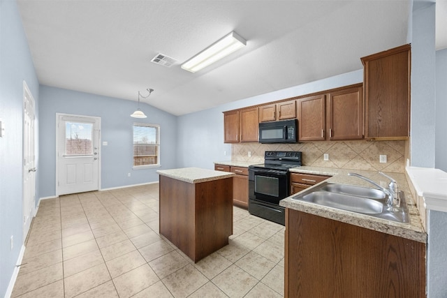 kitchen with vaulted ceiling, sink, black appliances, a kitchen island, and hanging light fixtures