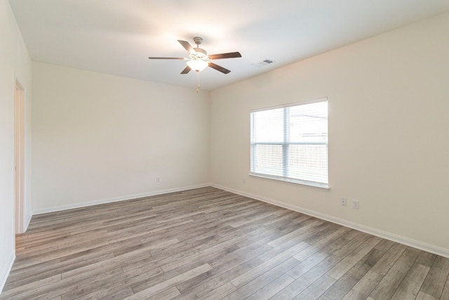 spare room featuring ceiling fan and light hardwood / wood-style flooring