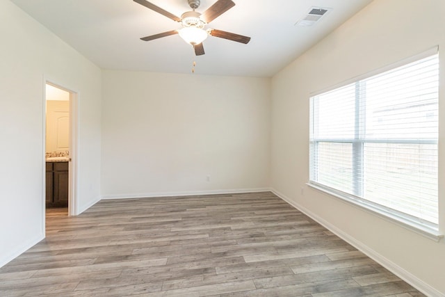 unfurnished room with light hardwood / wood-style flooring and ceiling fan