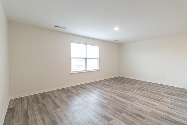 unfurnished room with light hardwood / wood-style flooring