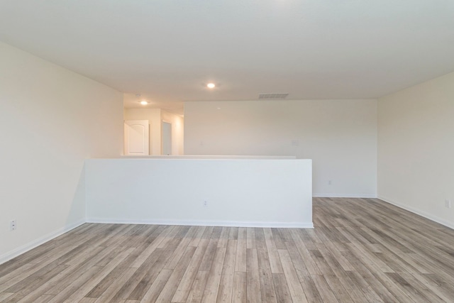 empty room with light hardwood / wood-style flooring