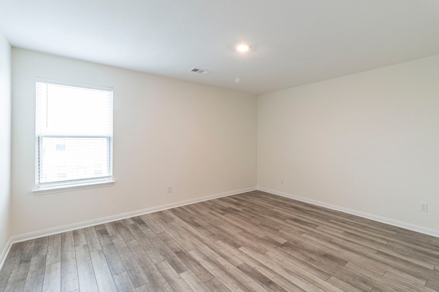 empty room with light hardwood / wood-style flooring