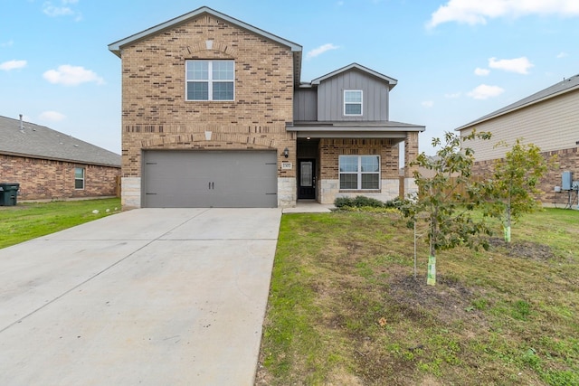 view of front of property with a front yard and a garage