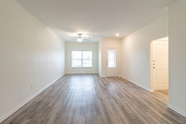 empty room with ceiling fan and hardwood / wood-style floors