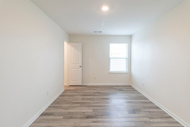 empty room with light hardwood / wood-style flooring