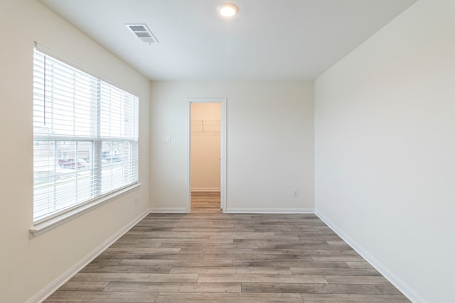 empty room with light hardwood / wood-style flooring