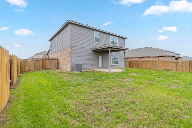 back of house featuring a lawn, central air condition unit, and a patio