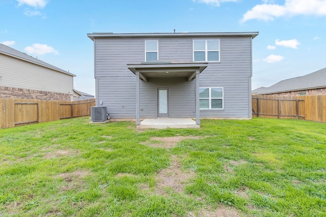 rear view of house with a yard, a patio, and central AC