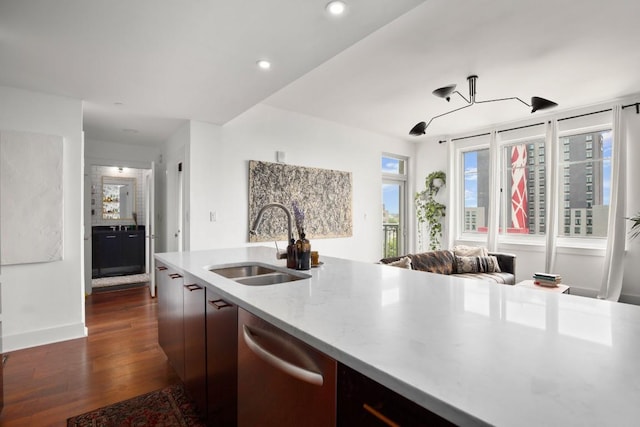 kitchen featuring dishwasher, dark hardwood / wood-style floors, dark brown cabinets, and sink