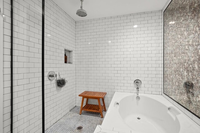 bathroom with tile patterned flooring, shower with separate bathtub, and tile walls