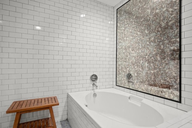 bathroom featuring a relaxing tiled tub and tile walls