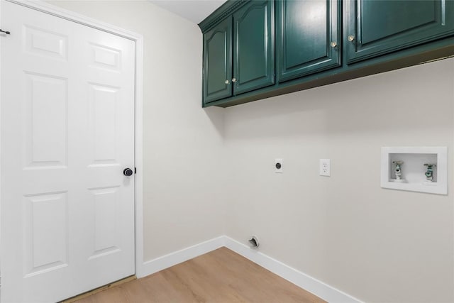 washroom featuring washer hookup, hookup for an electric dryer, cabinets, and light hardwood / wood-style floors