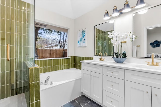 bathroom with tile patterned floors, vanity, and independent shower and bath