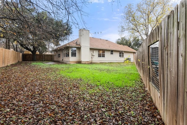 rear view of house with a lawn