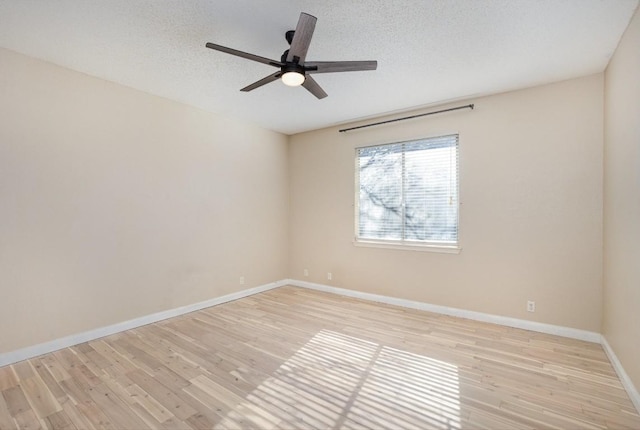 unfurnished room featuring a textured ceiling, light wood-type flooring, and ceiling fan