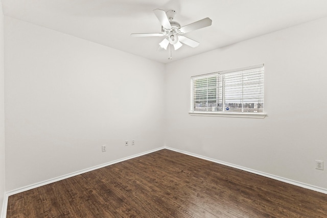 empty room with ceiling fan and dark hardwood / wood-style flooring