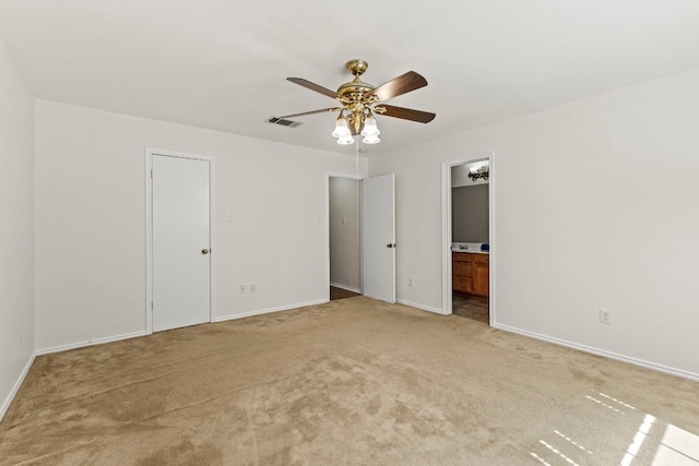 carpeted spare room with ceiling fan