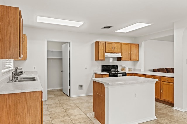 kitchen with black / electric stove, sink, a kitchen island, and light tile patterned flooring