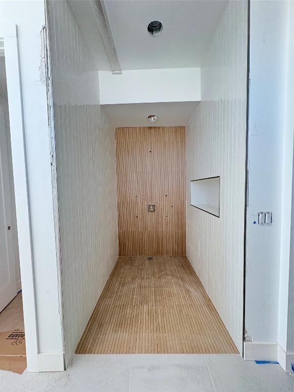 hallway with light tile patterned floors