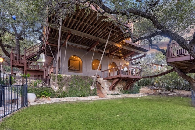 rear view of property with a deck and a yard